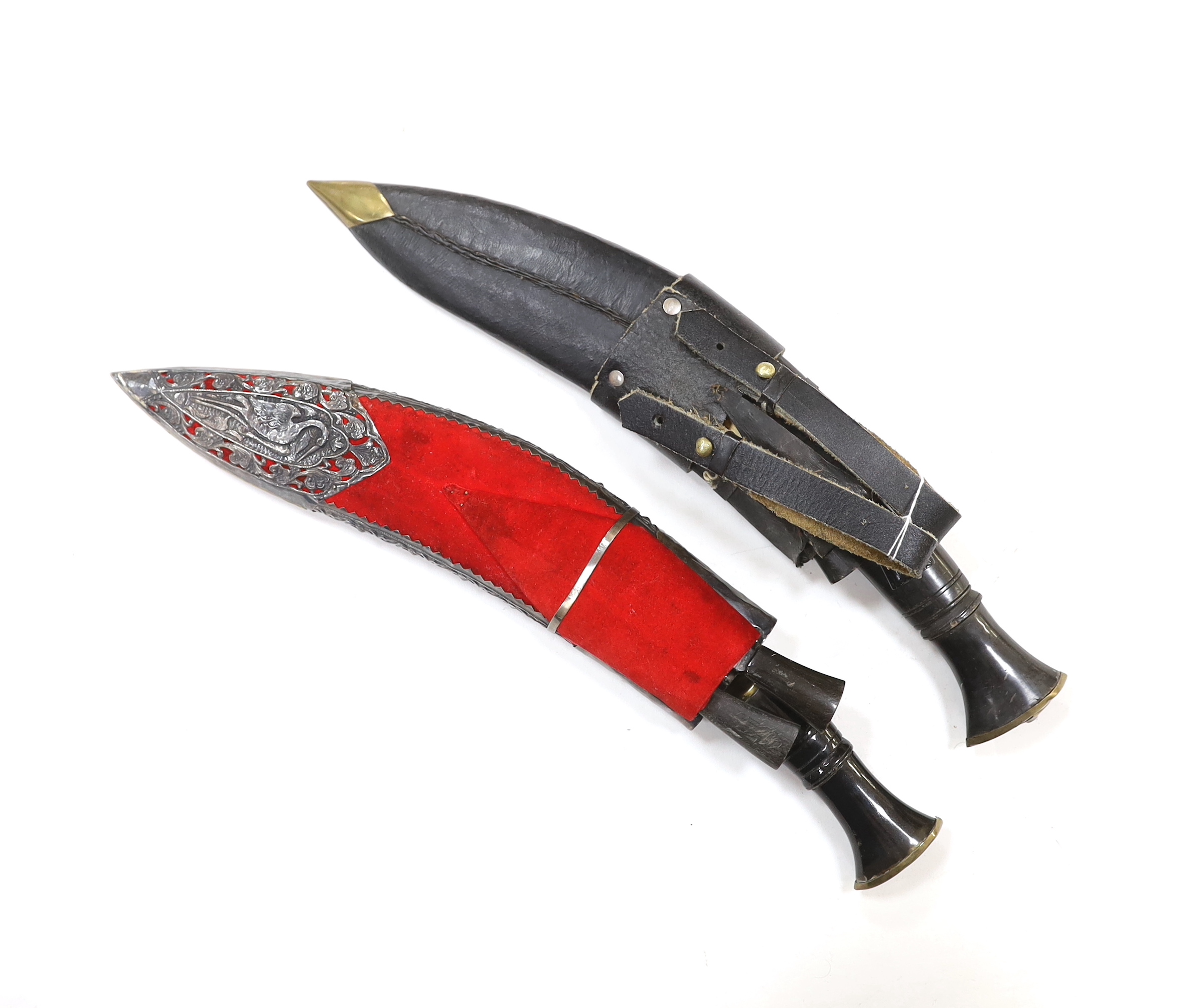 Two Kukri daggers in scabbards also containing two smaller daggers
